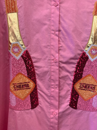 Pink sequin button-down mini dress with metallic champagne bottle embroidery. Short-sleeve A-line flare cut. The perfect statement party dress!
