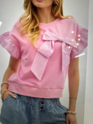 Soft pink top with ruffle sleeves and big bow
Breast cancer awareness month