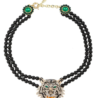 Unleash your ferocity with this commanding necklace. Deep black onyx beads form a powerful chain, leading the eye to a majestic tiger pendant—the ultimate symbol of untamed power. Pair it with a simple gold bracelet for a complete, unstoppable jewelry set.