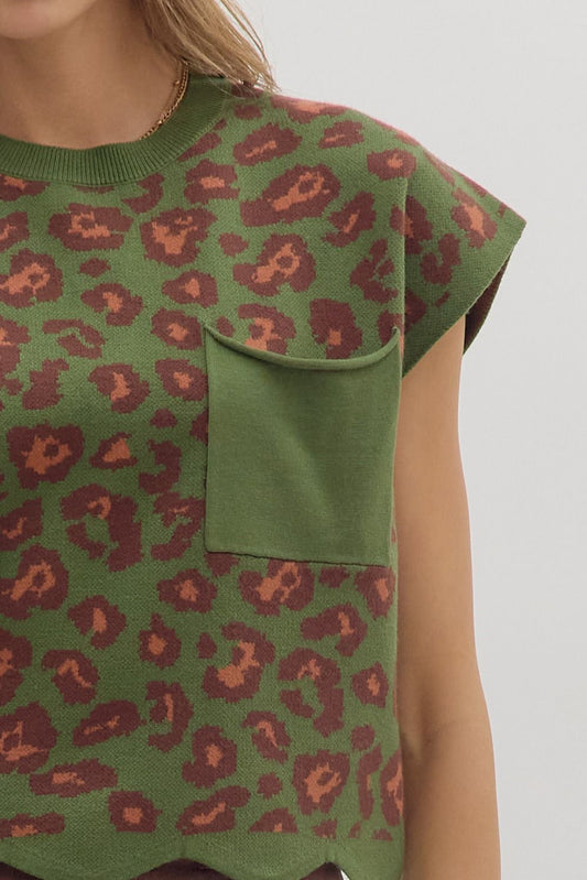 Animal print cap sleeve knit top featuring chest patch pocket and scallop edge hem. Unlined. Knit. Non-sheer. Lightweight.